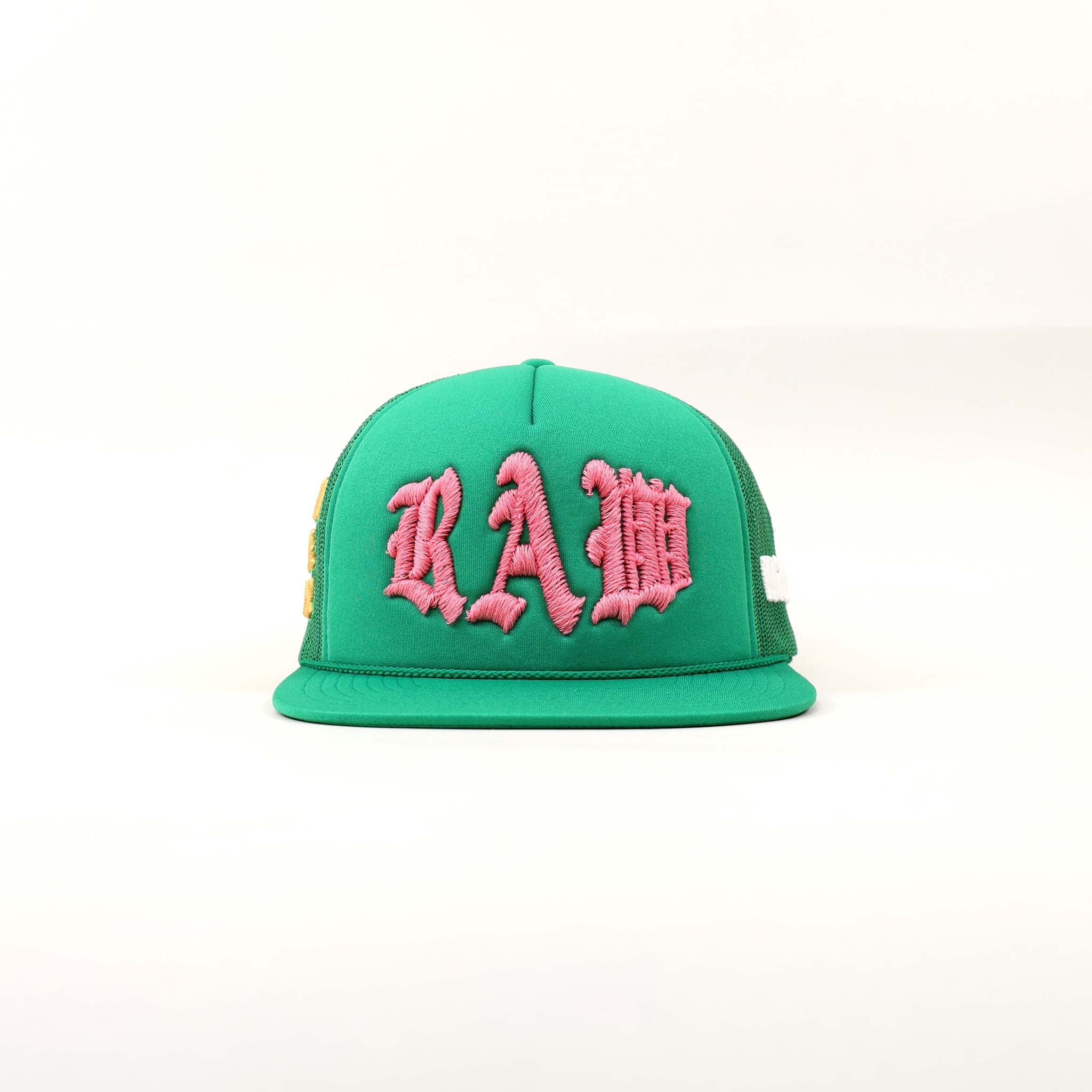Green cap with pink "RAW" embroidery.