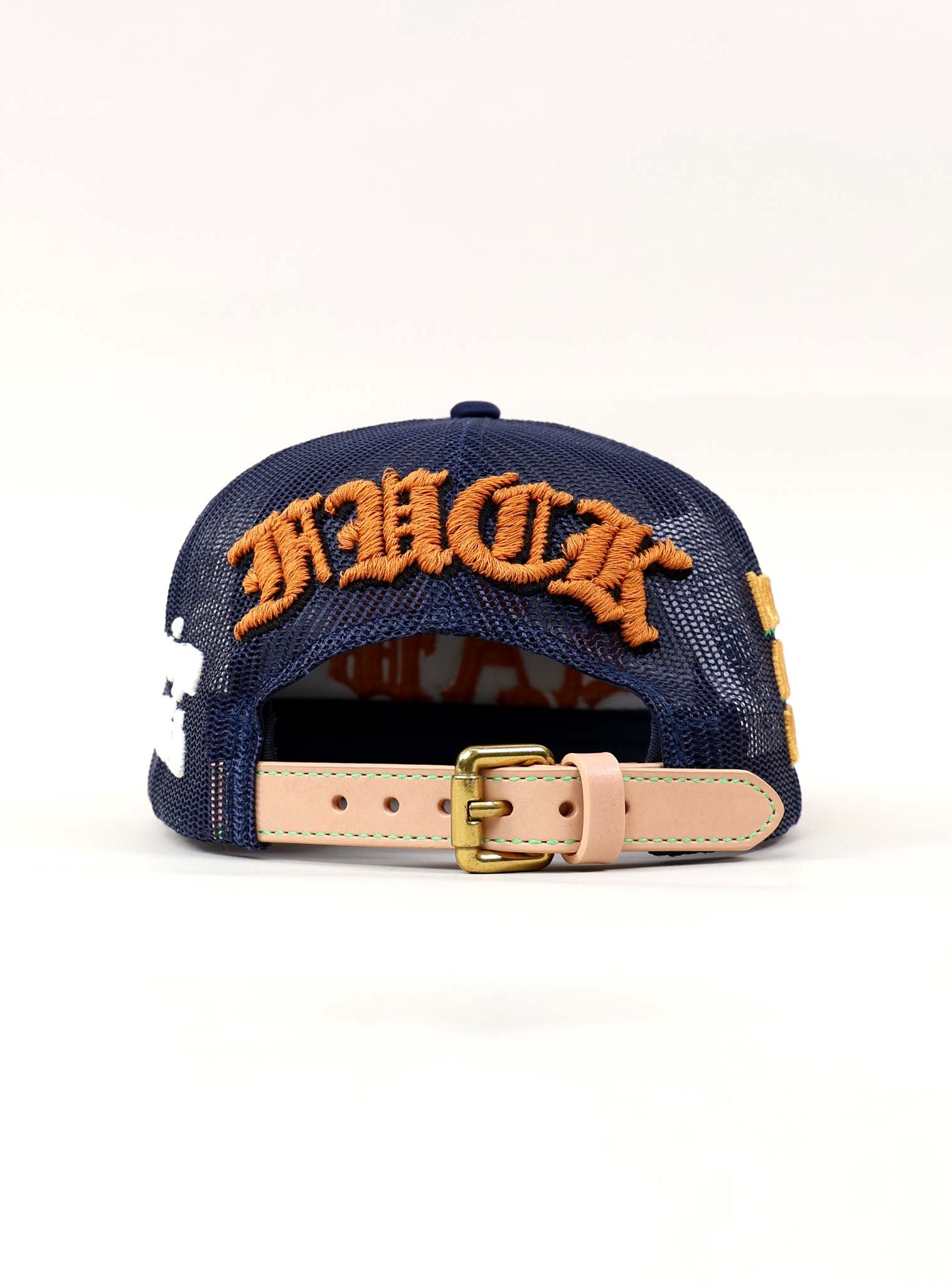 Back view of navy cap with orange embroidery.