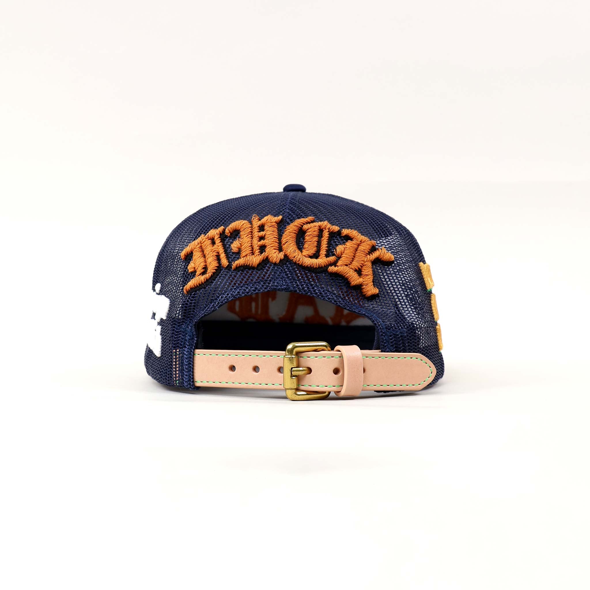 Back view of navy cap with orange embroidery.