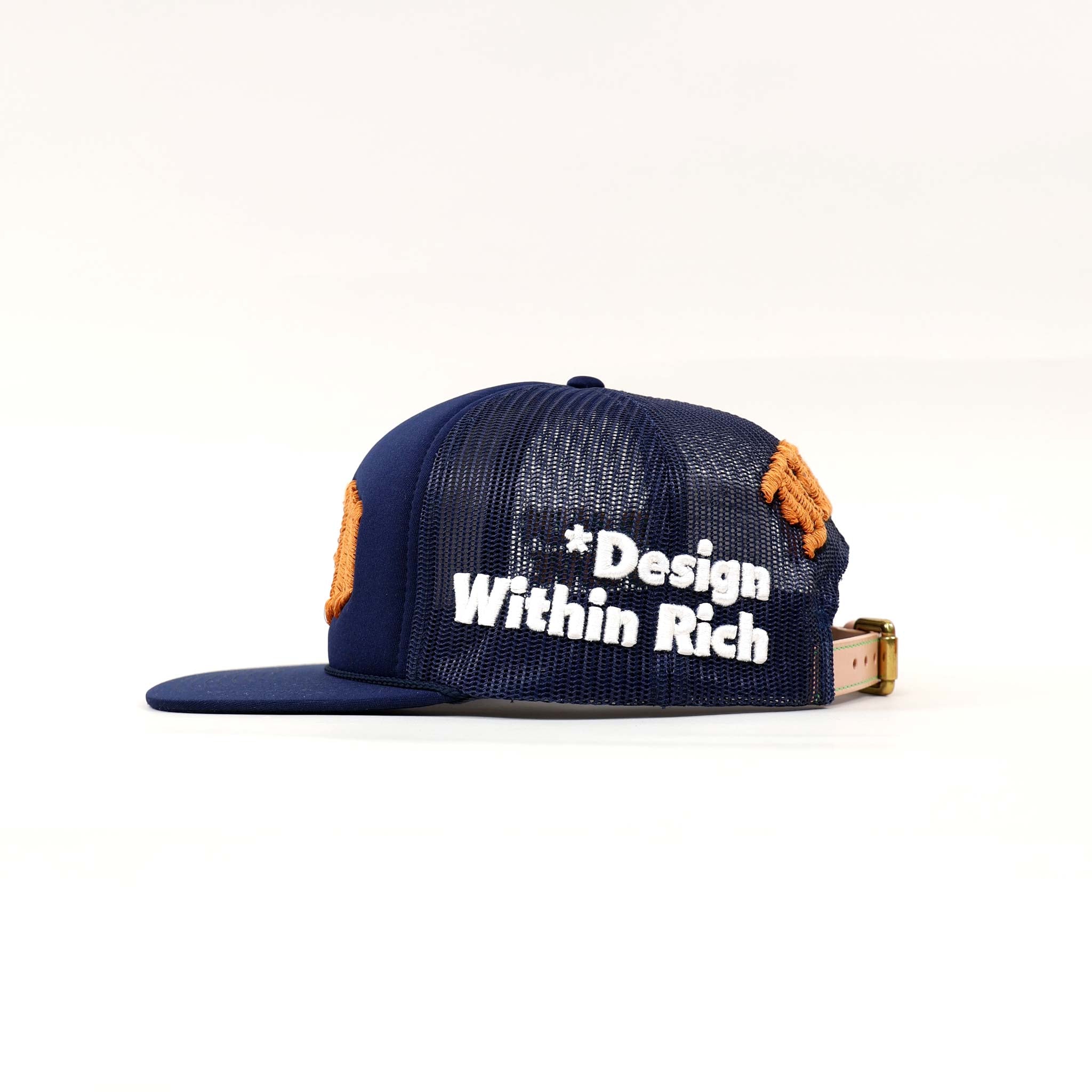 Blue mesh cap with "Design Within Rich" text.