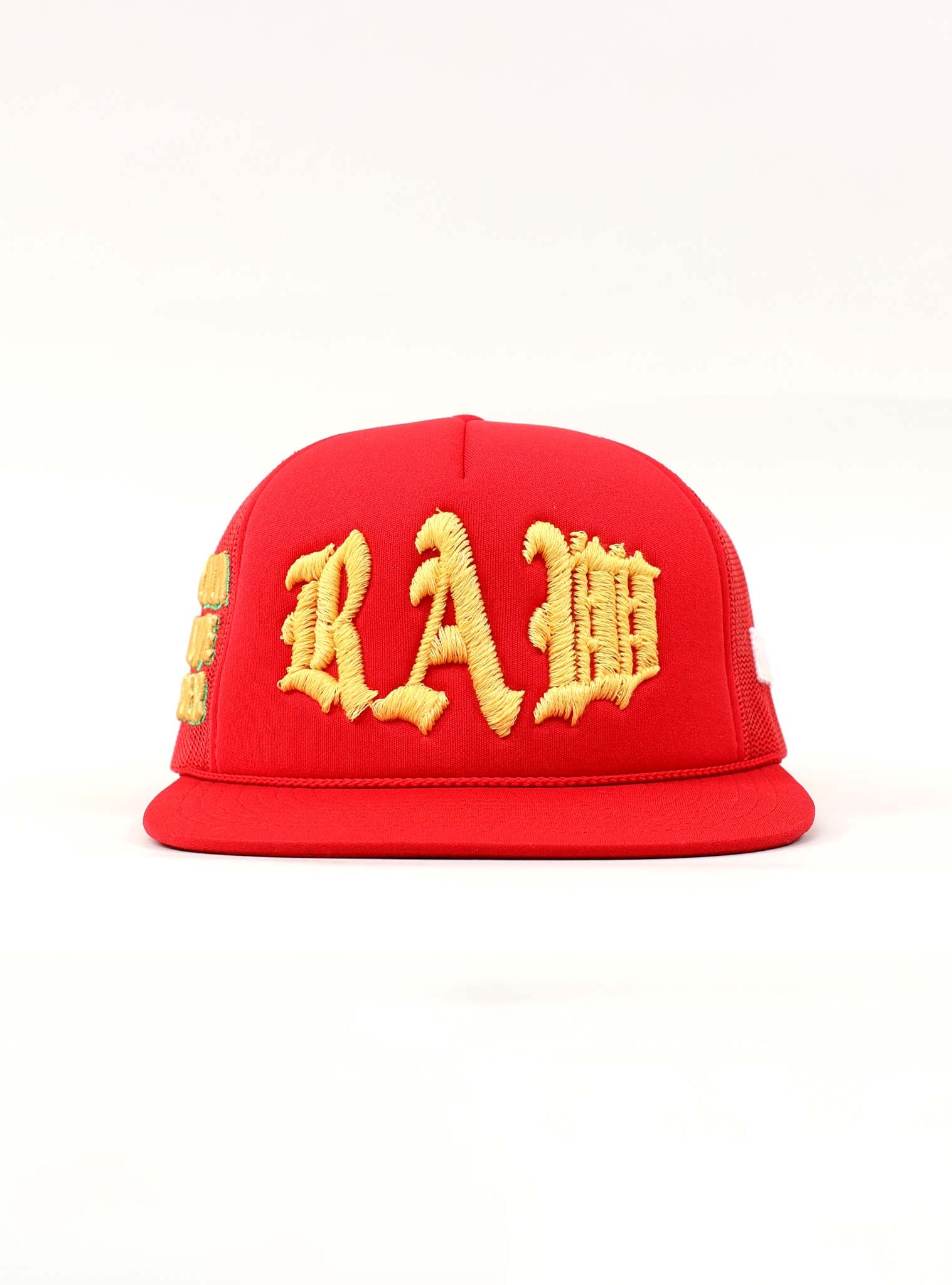 Red cap with yellow embroidered letters.