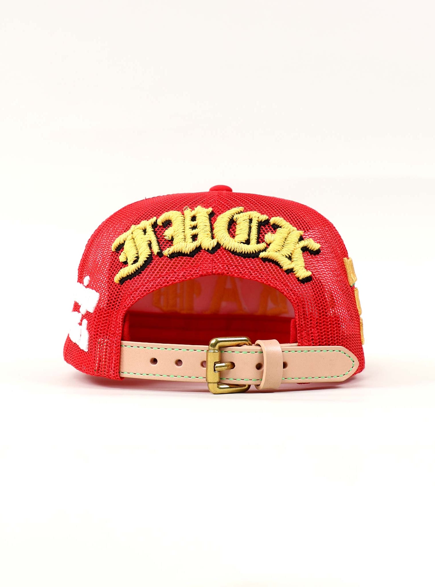 Red cap with bold yellow embroidery.