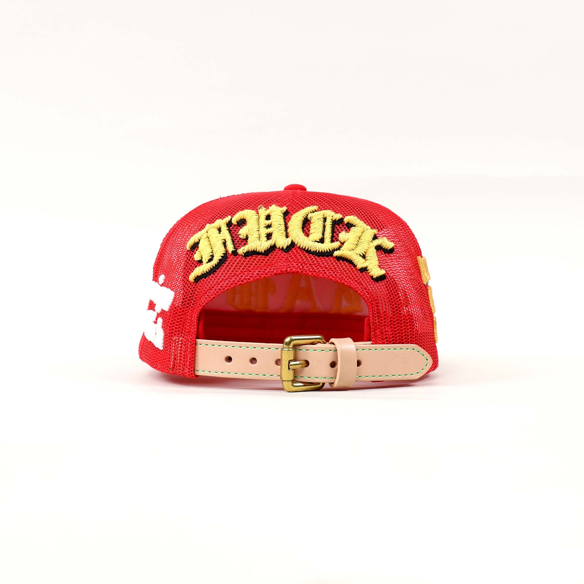 Red cap with bold yellow embroidery.