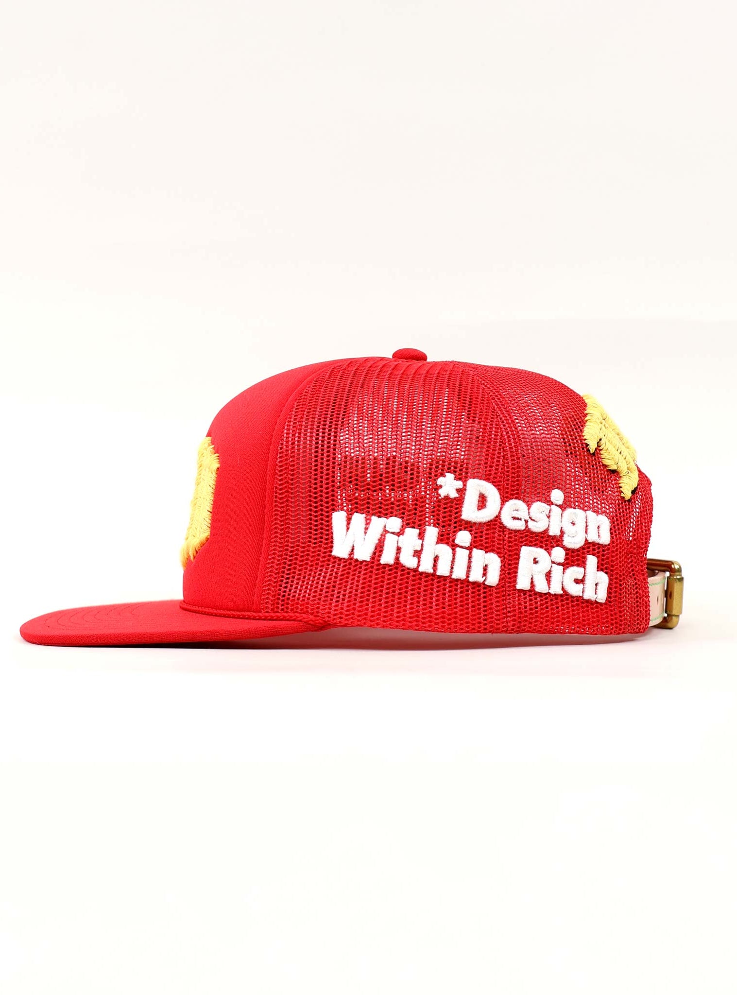 Red mesh cap with "Design Within Rich" text.
