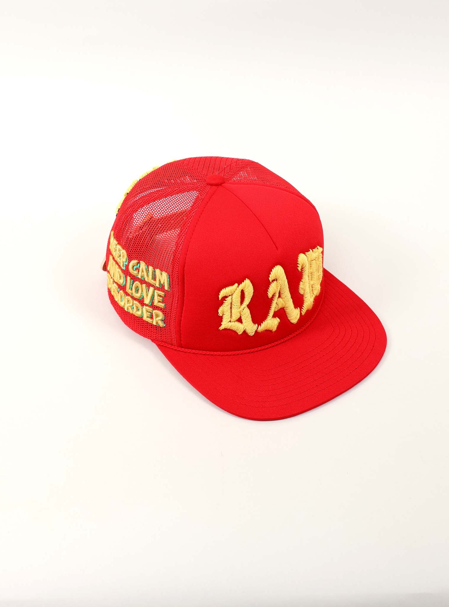 Red cap with yellow embroidered text.
