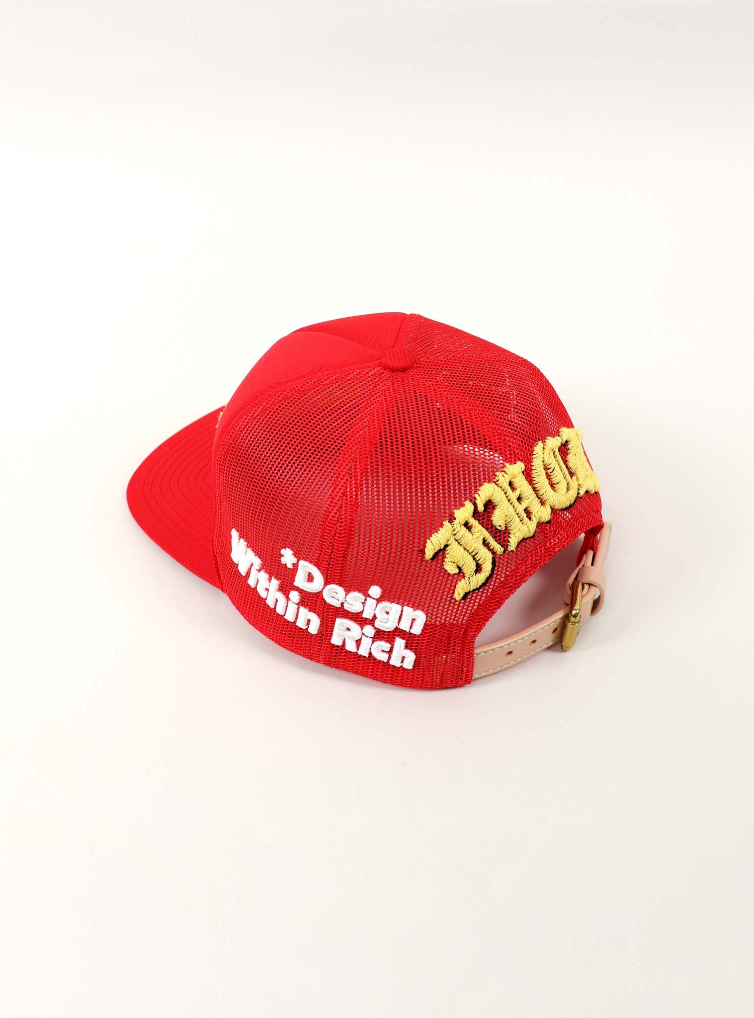 Red cap with "Design Within Rich" text.