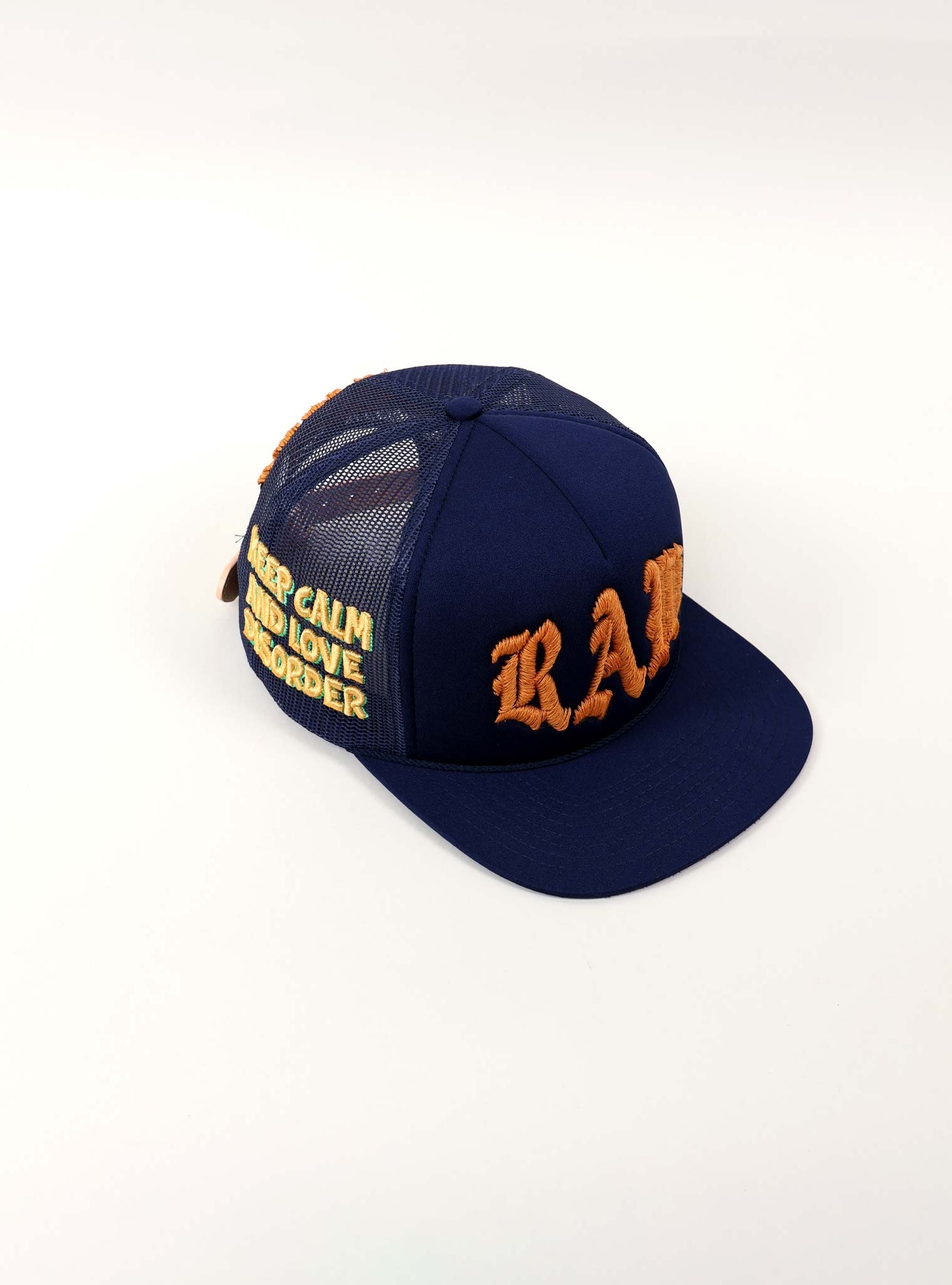 Blue cap with orange embroidered text.