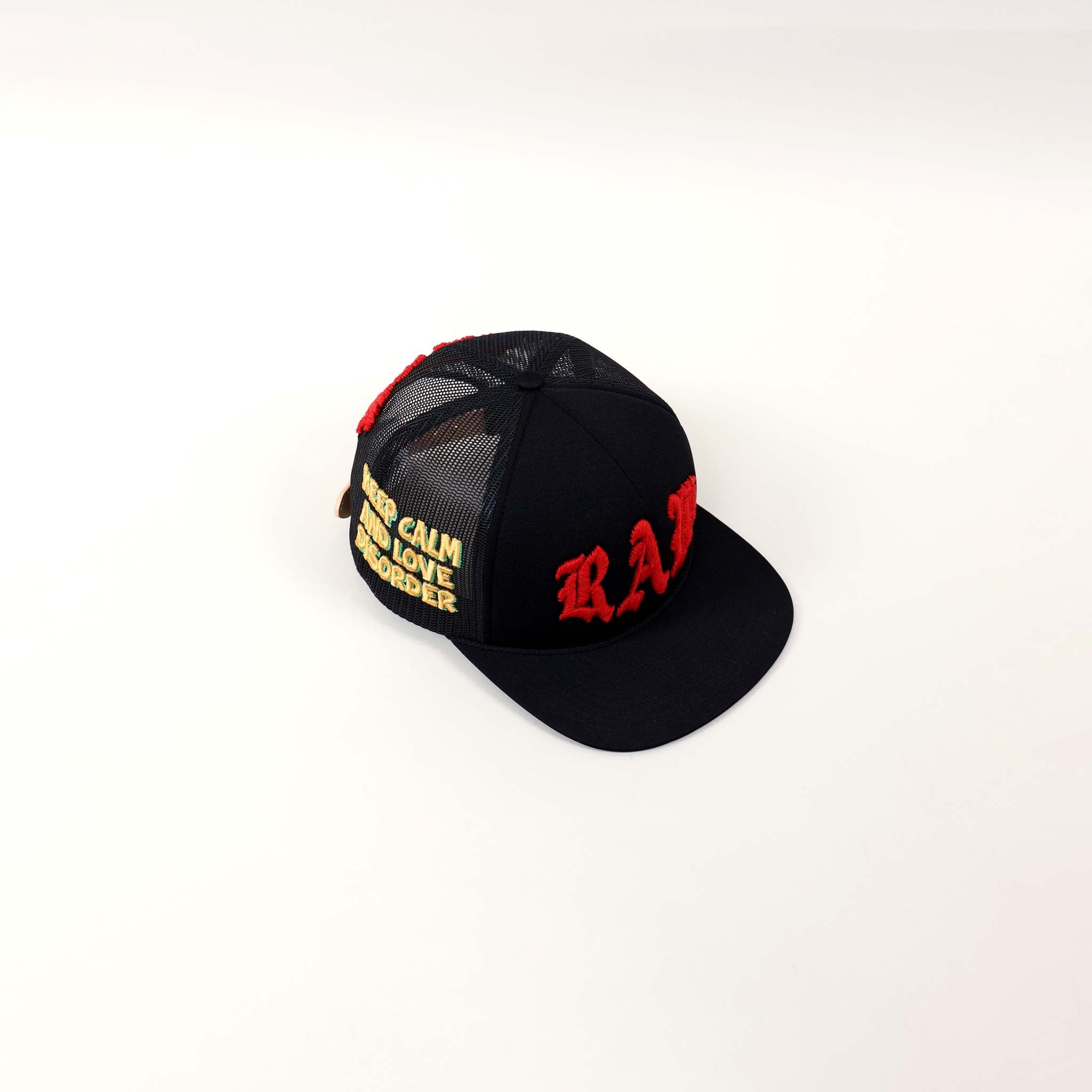 Black cap with red and yellow embroidery.