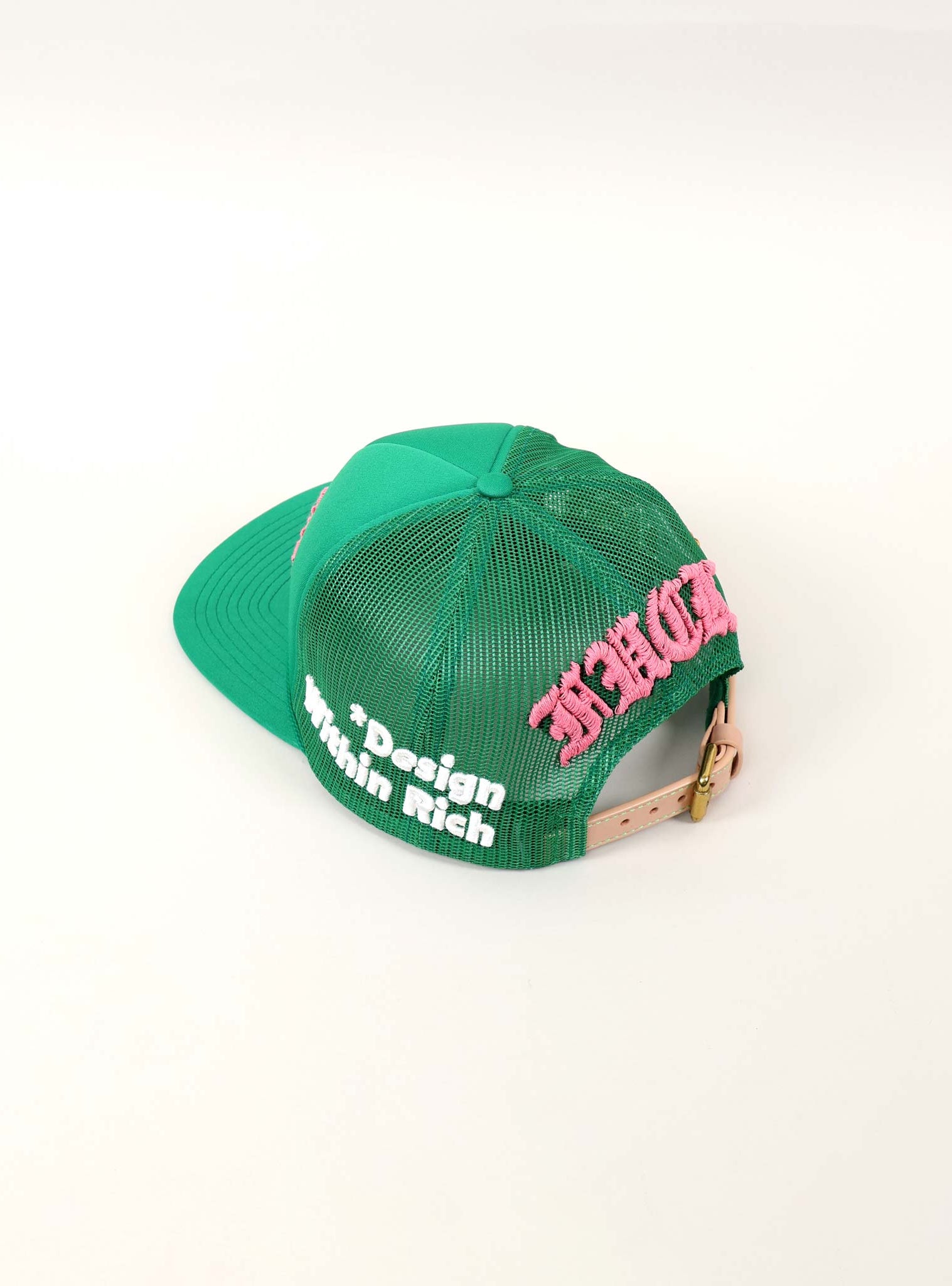 Green mesh cap with pink and white text.