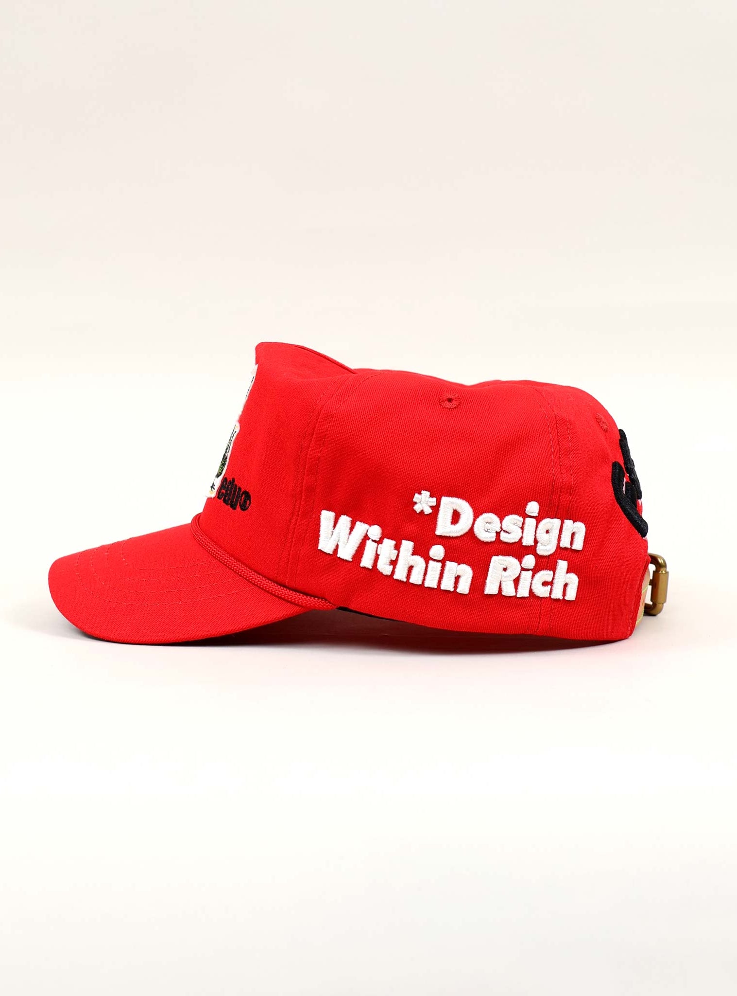 Red cap with "Design Within Rich" text.