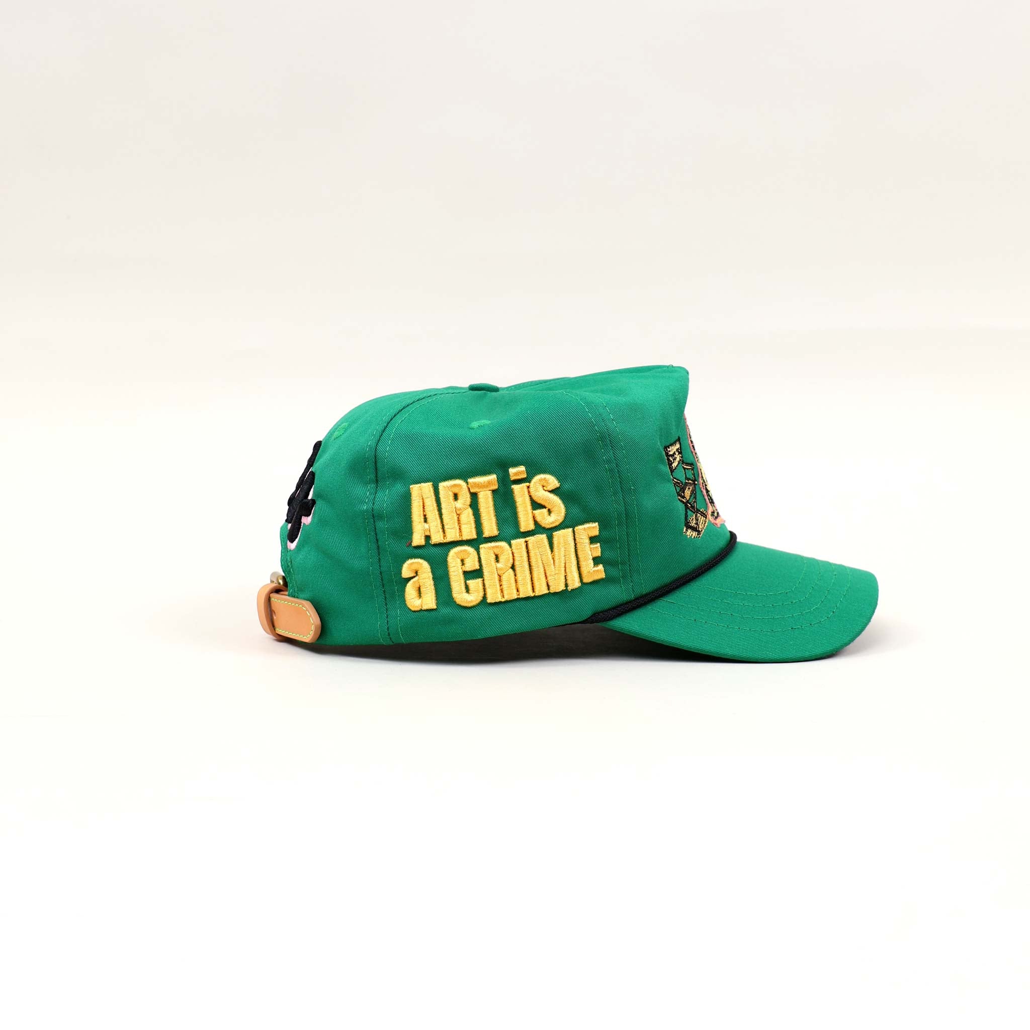 Green cap with "ART is a CRIME" text.