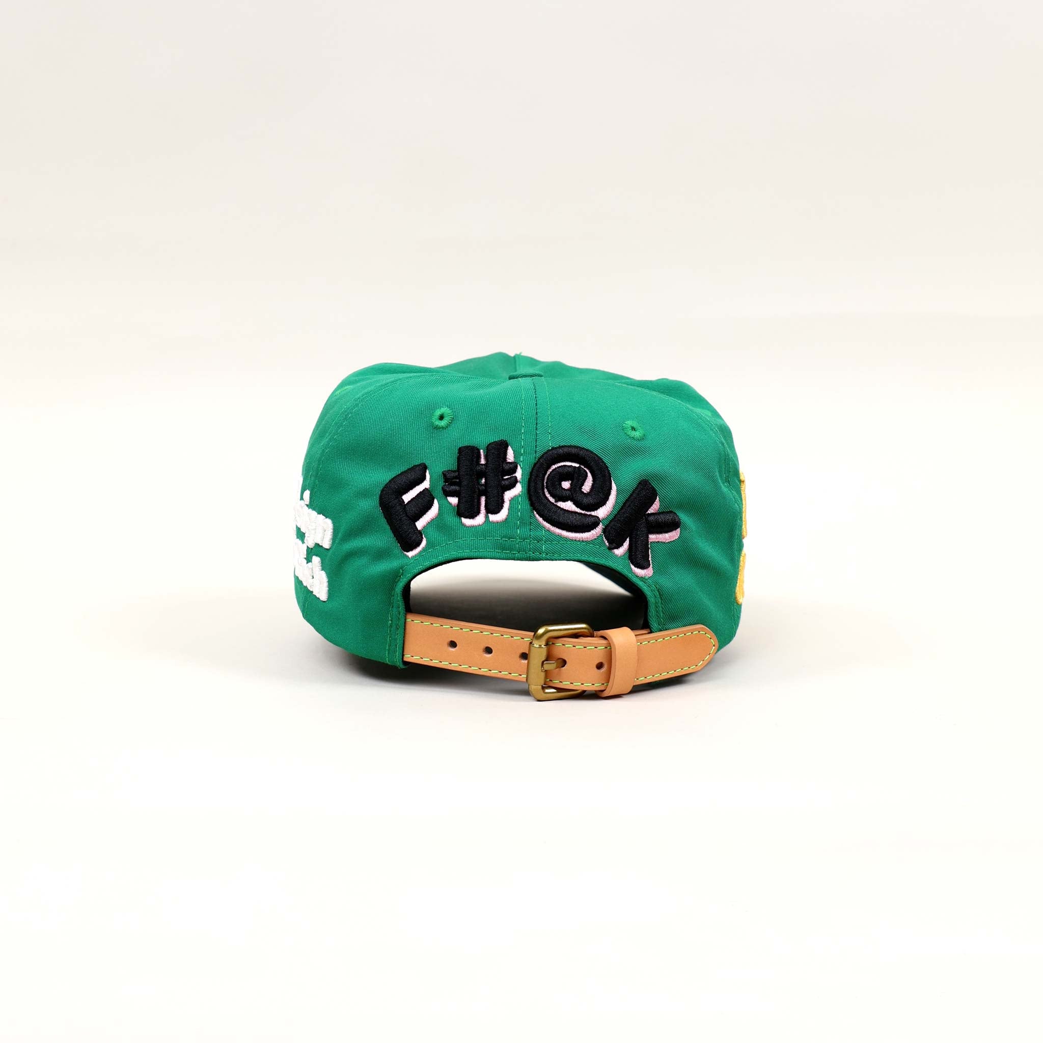 Green cap with embroidered text on the back.
