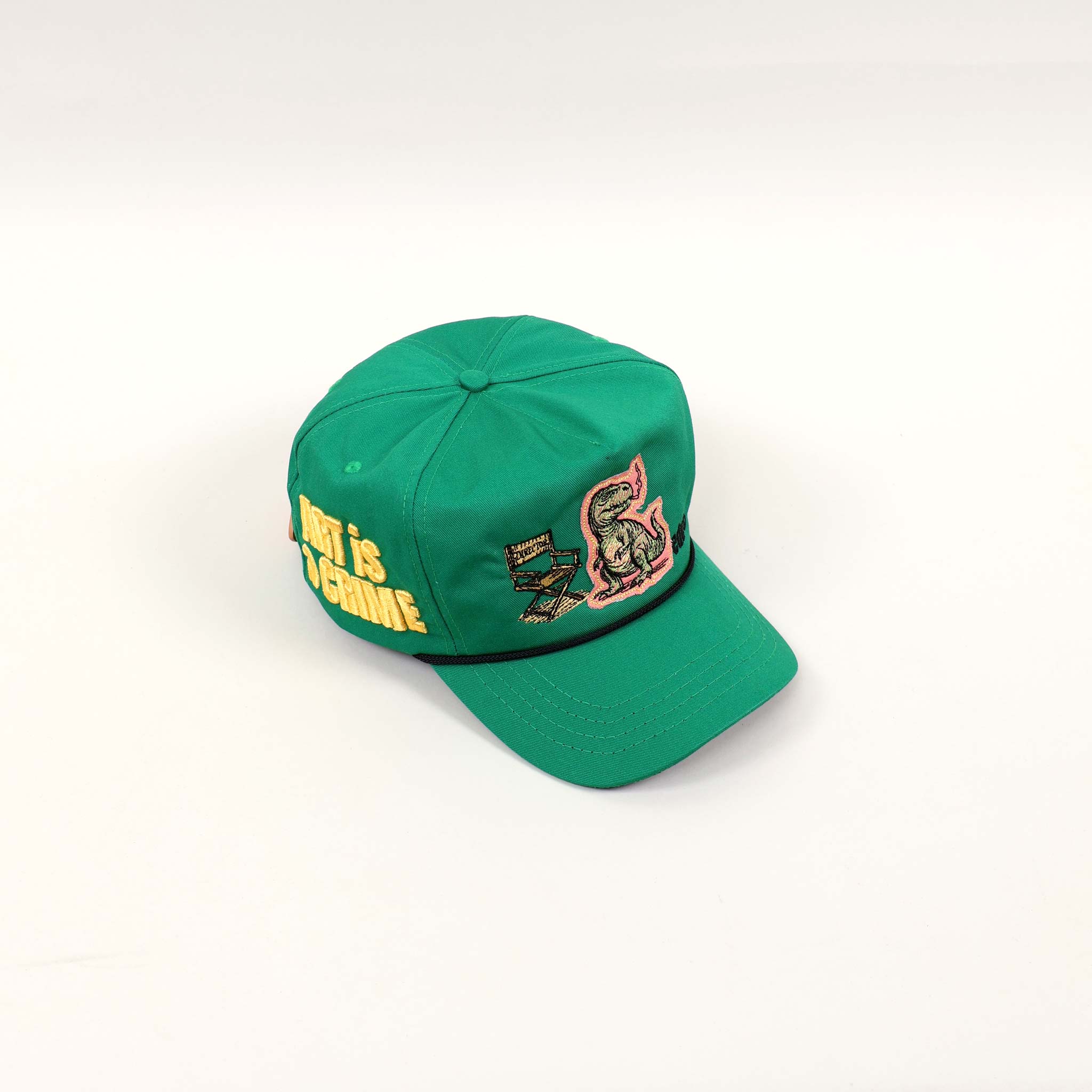 Green cap with dinosaur and "Art is Genius" text.