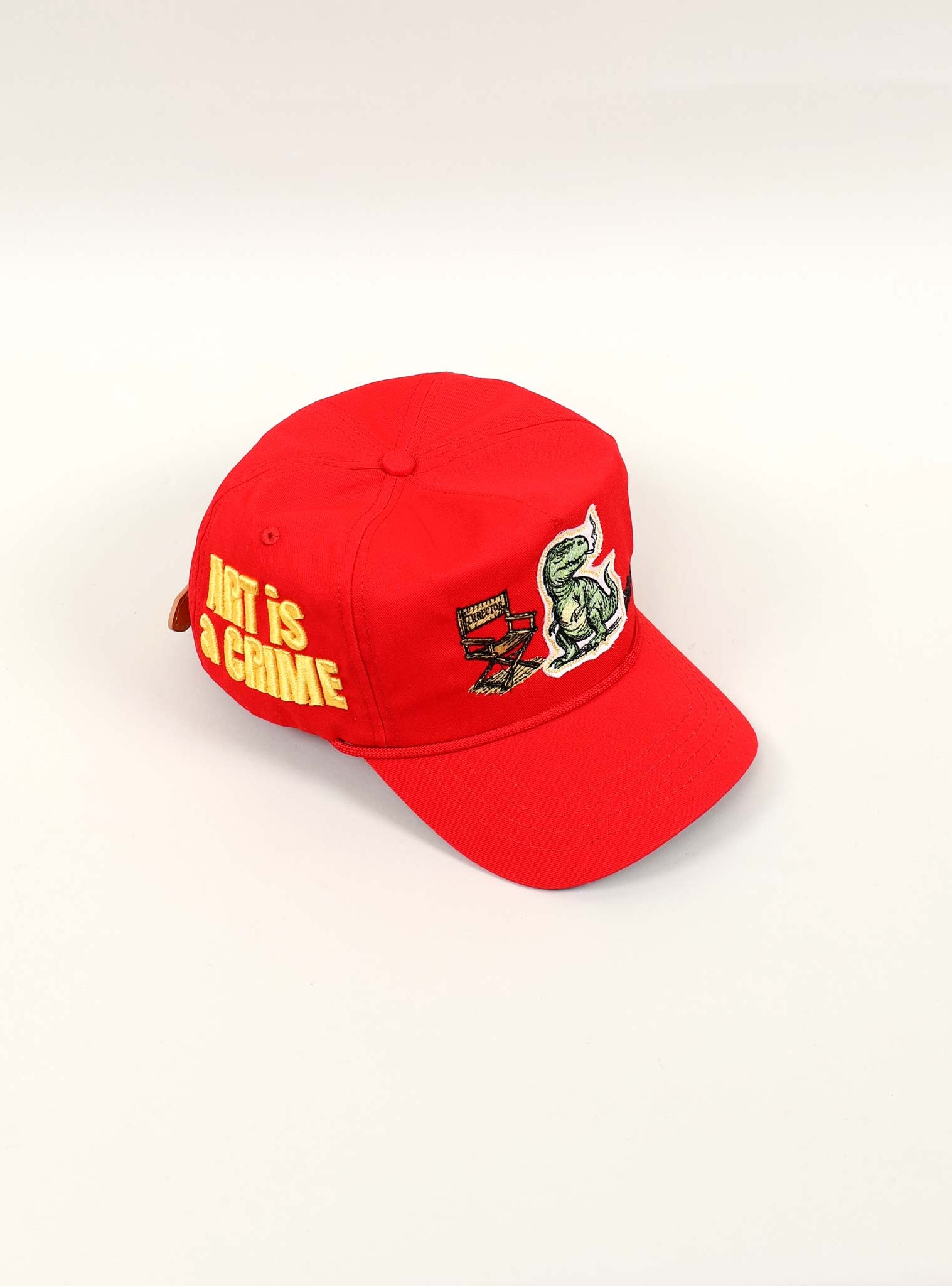 Red cap with "Art is a Crime" text.