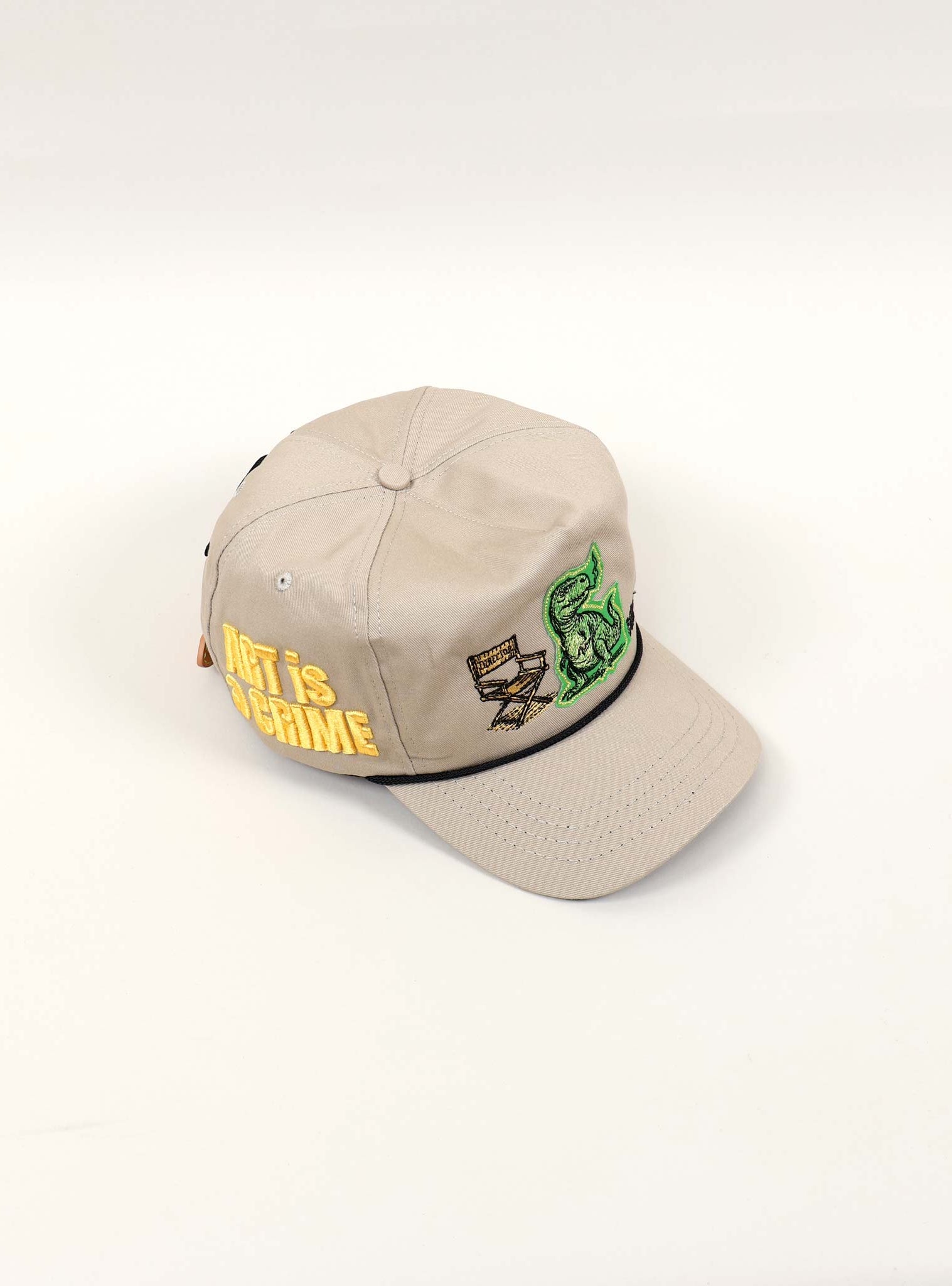Beige cap with embroidered designs and text.