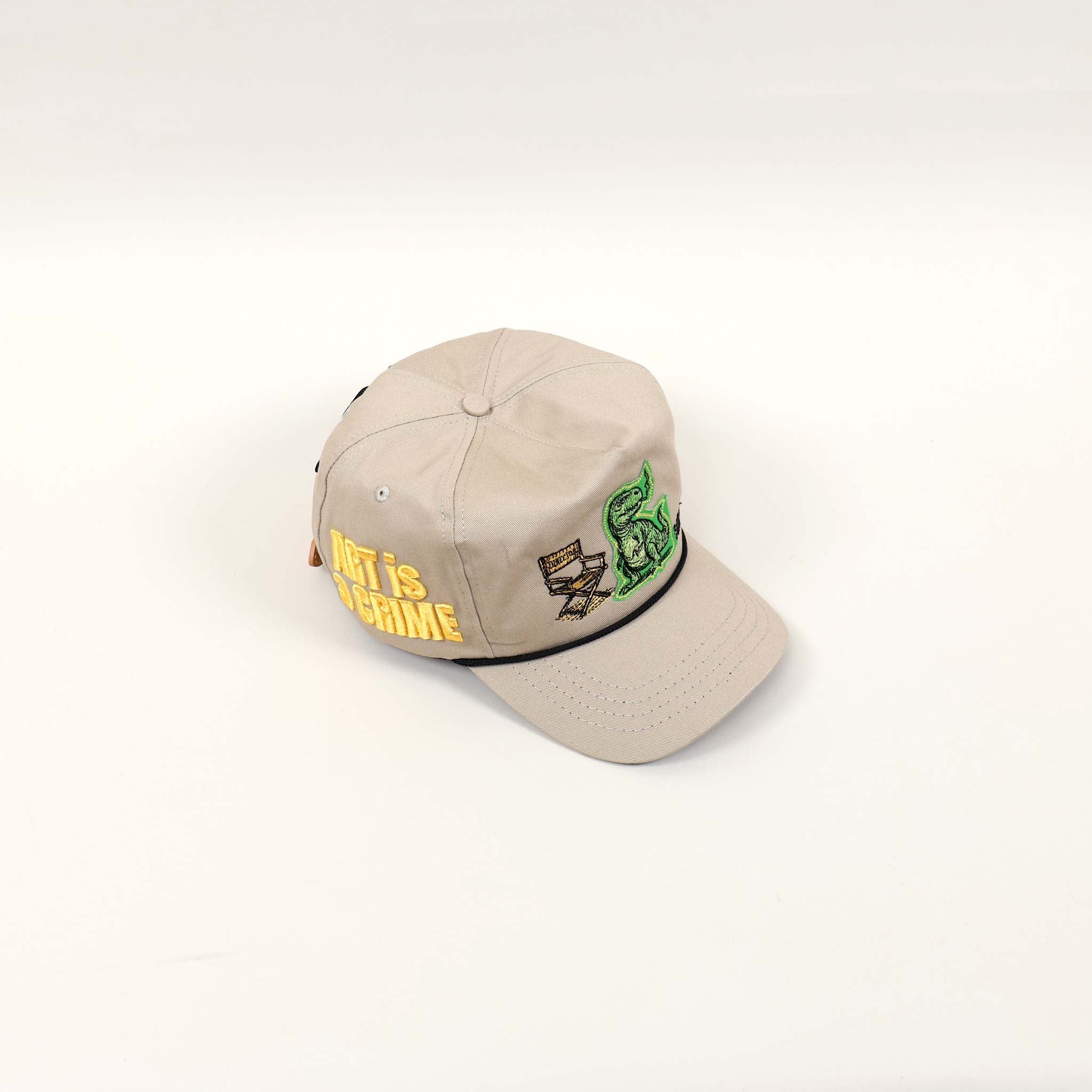 Beige cap with embroidered designs and text.
