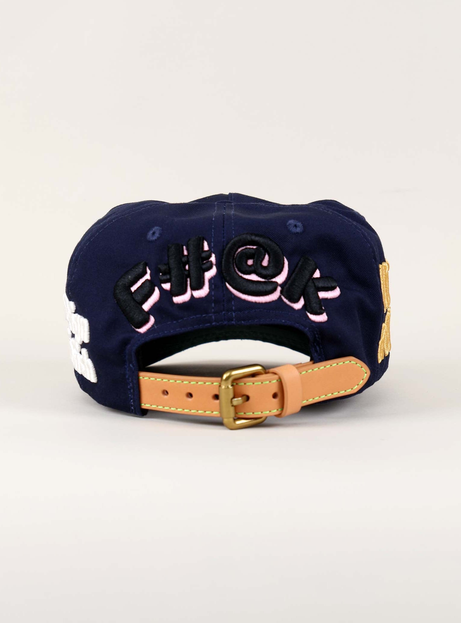 Navy cap with embroidered text on the back.