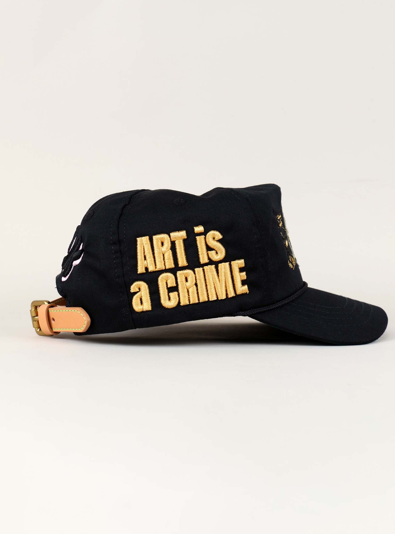Black cap with "Art is a Crime" text.
