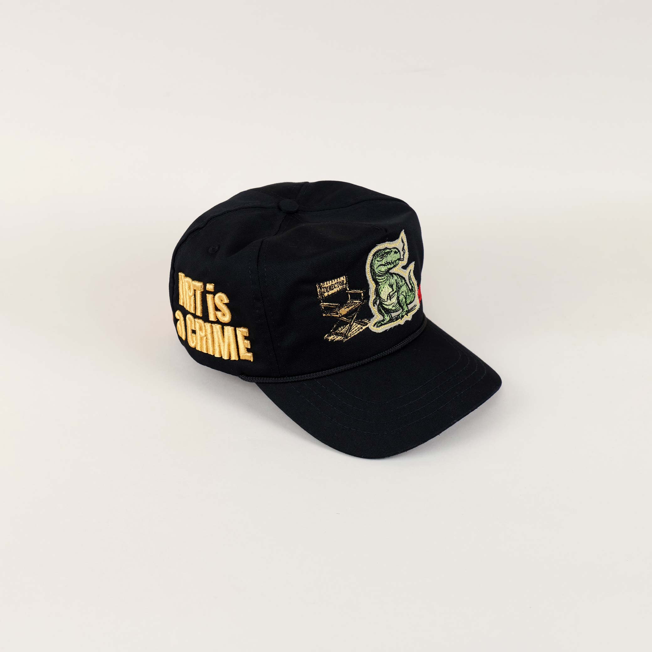 Black cap with dinosaur and text embroidery.