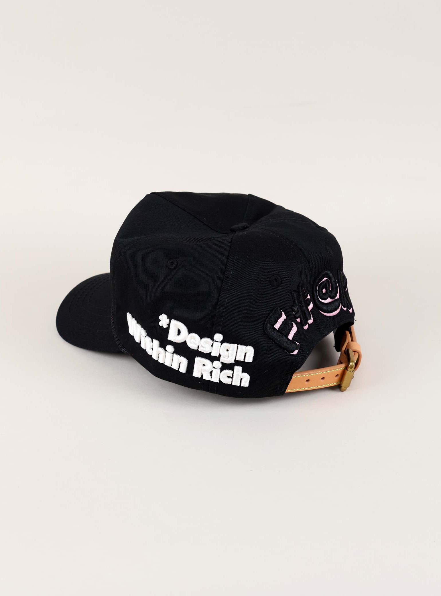 Black cap with "Design Within Reach" text.