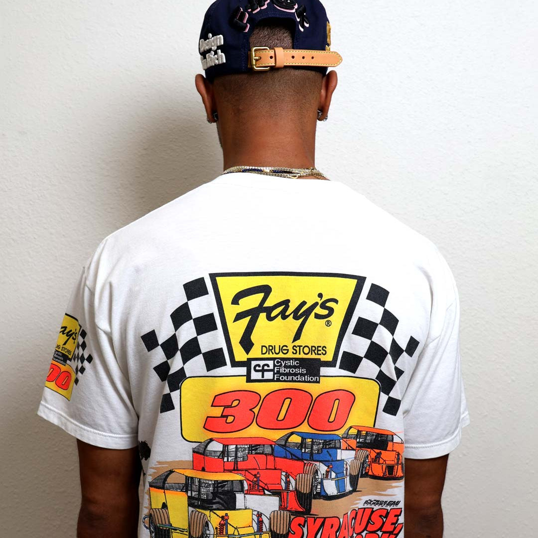 Man wearing racing-themed T-shirt and cap.