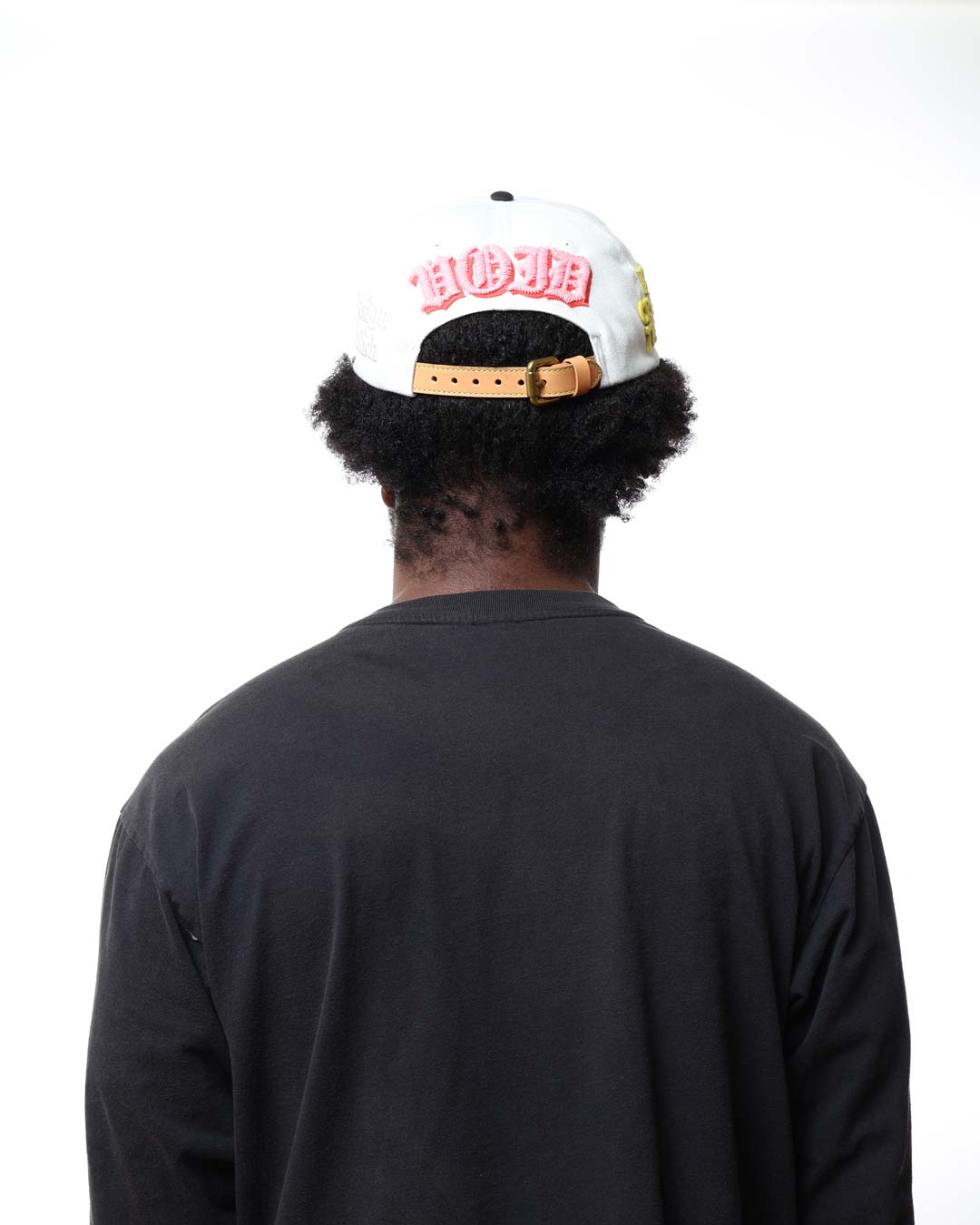 Person wearing a white cap with red text on a white background