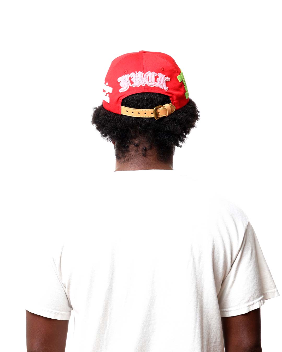 Person wearing a red cap with white text on a white background