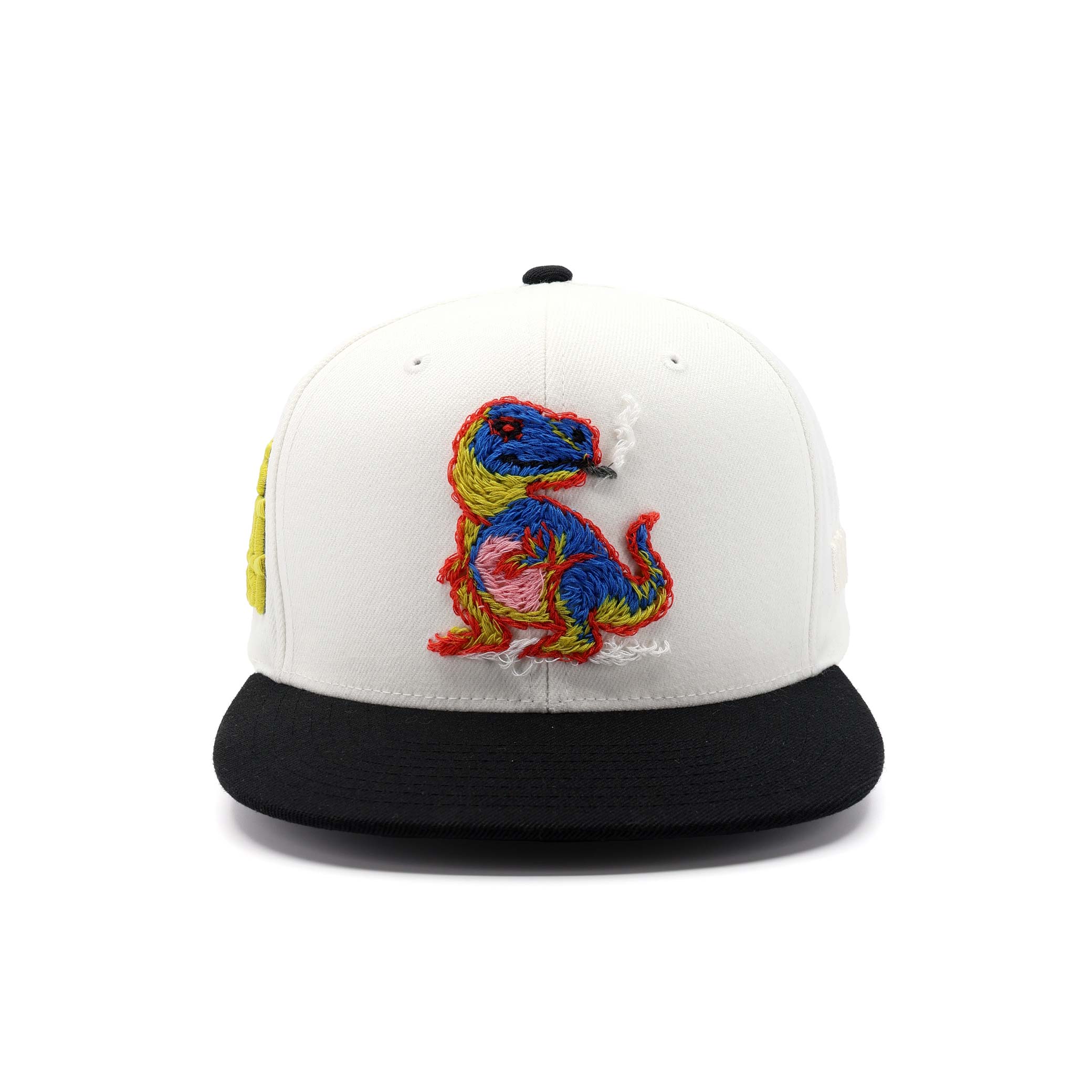 White cap with black brim featuring a colorful embroidered dinosaur design on a white background