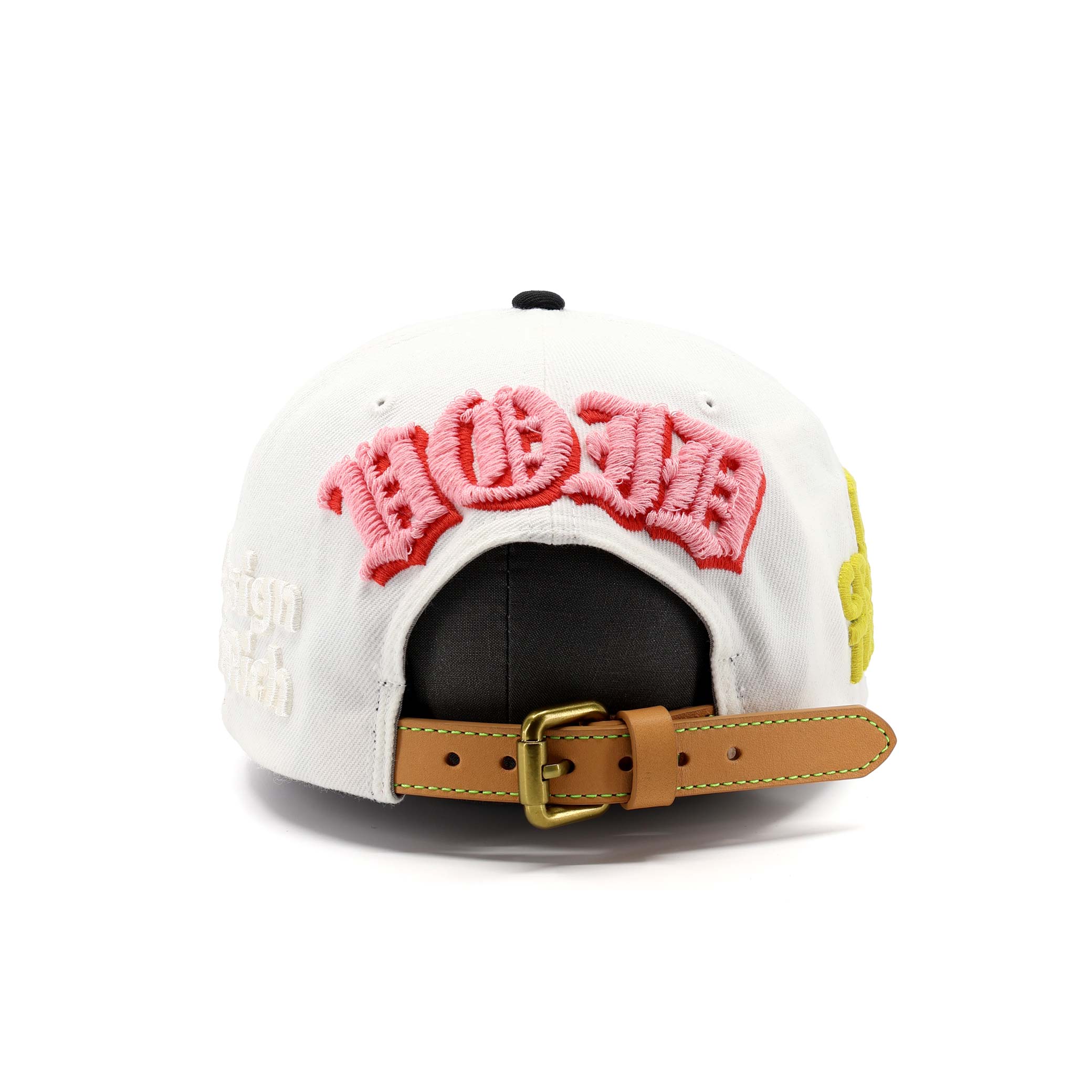 White cap with pink text and brown leather strap on a white background