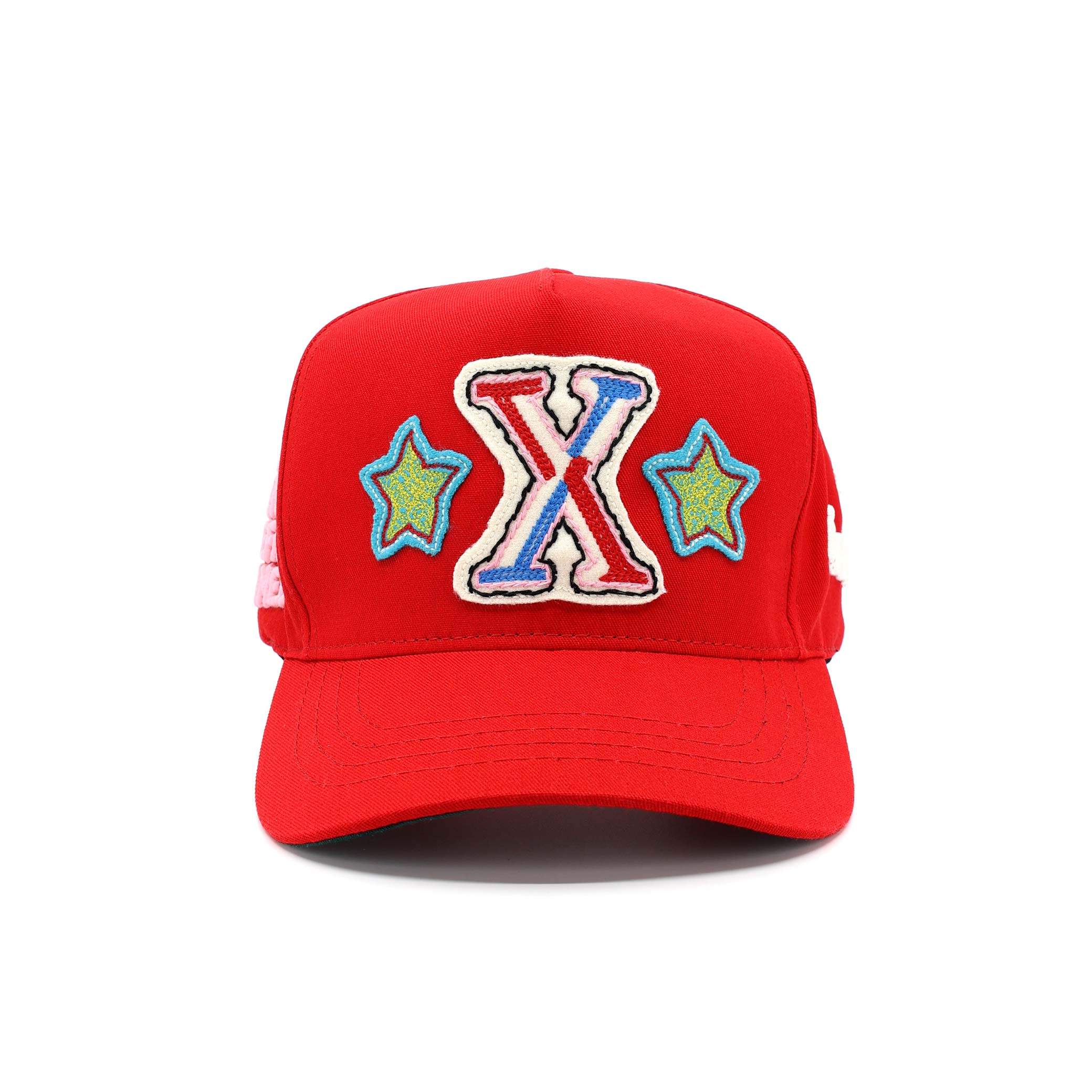 Red cap with colorful 'X' and star designs on a white background