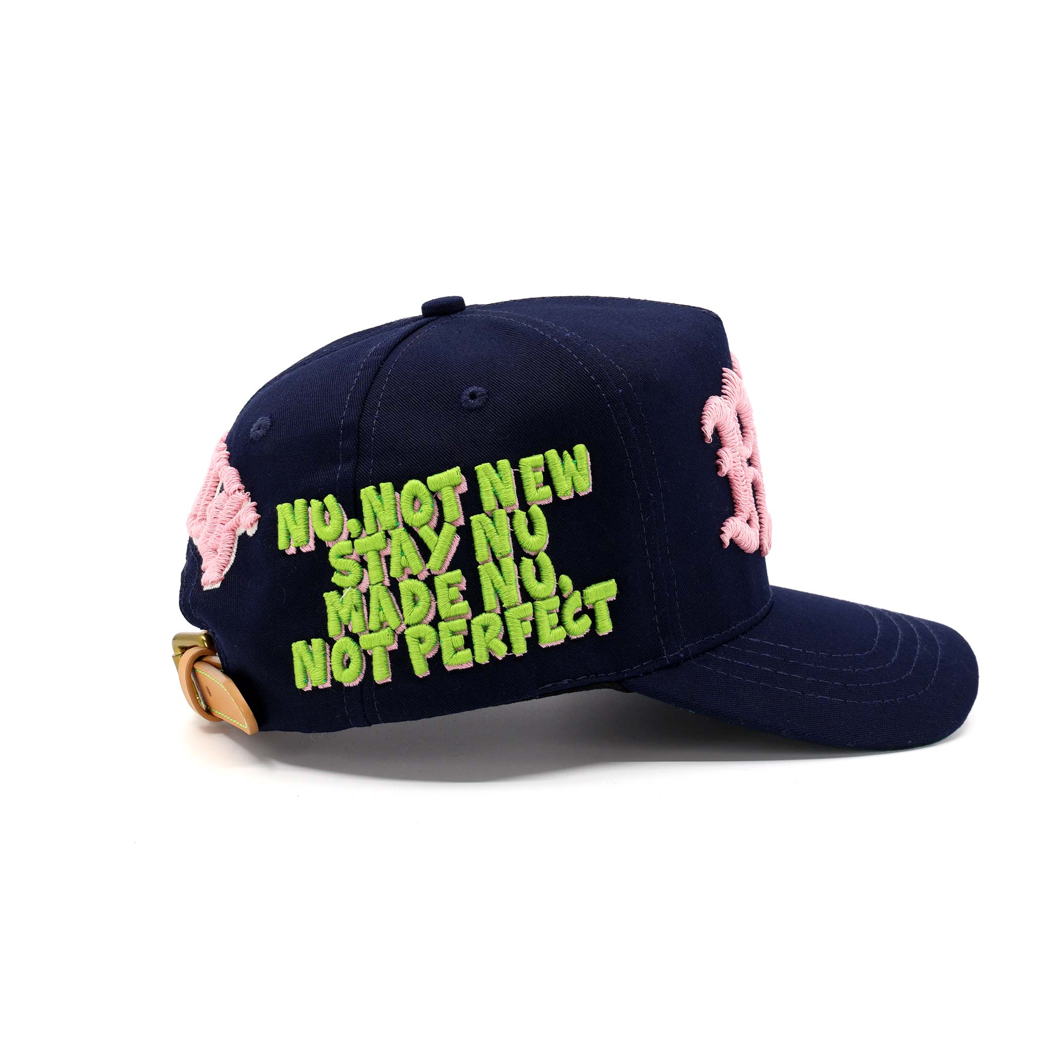 Navy blue cap with pink floral embellishments and neon green text on a white background