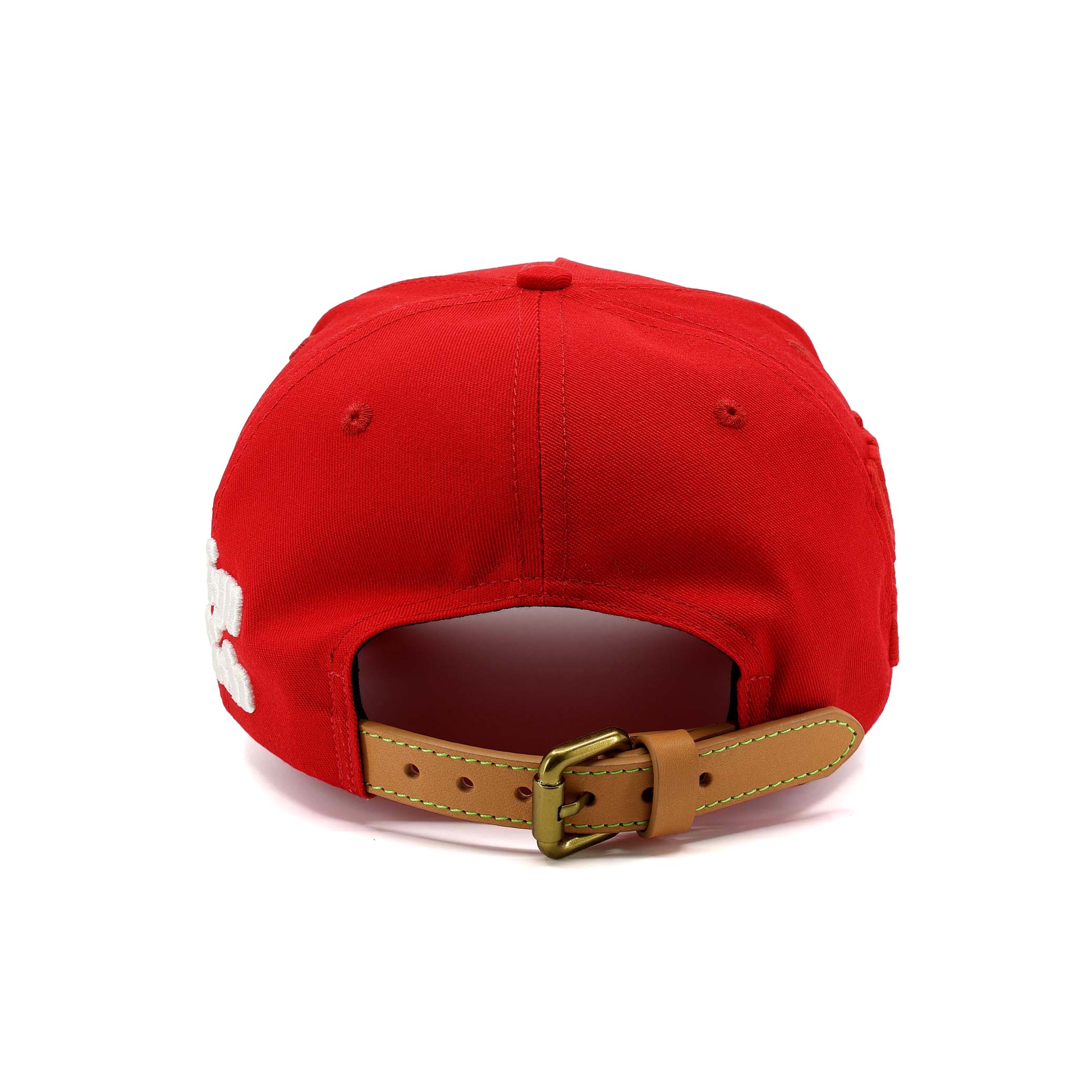 Red cap with a brown leather strap on a white background
