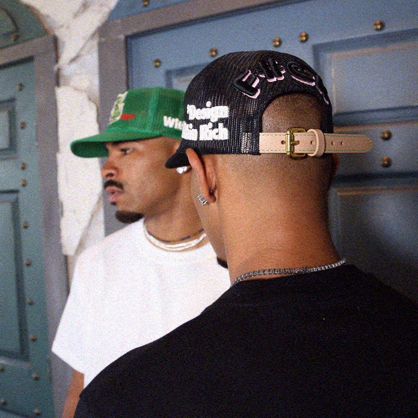 Black and white trucker hat with text on side.