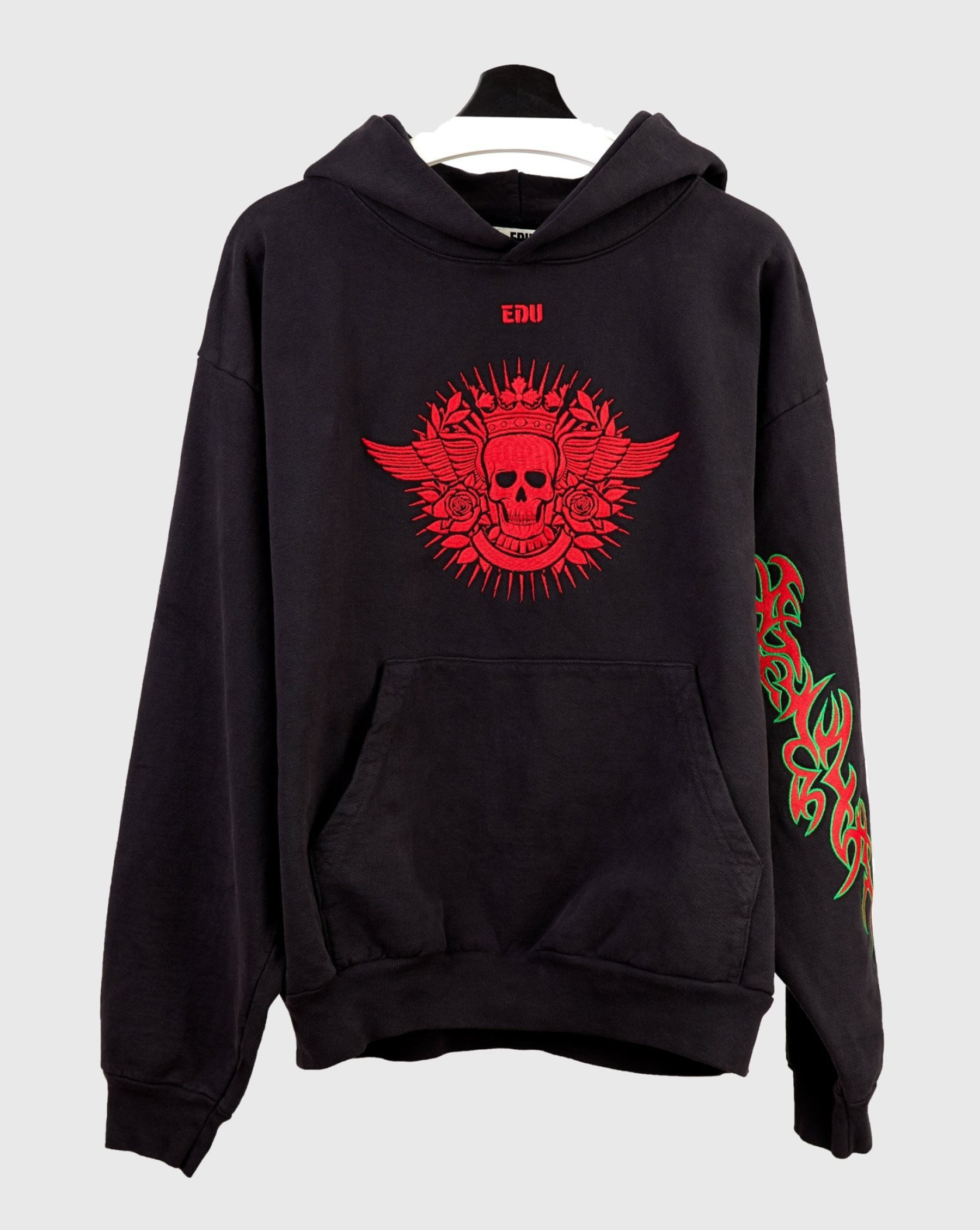 Black hoodie with red skull and wing design.