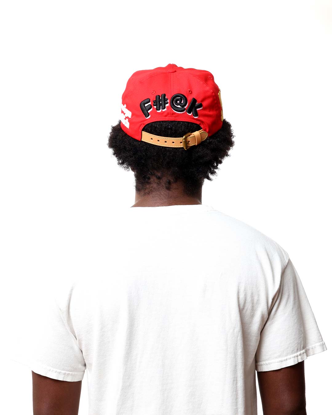 Person wearing a red cap with black text on a white background