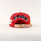 Red cap with bold text and adjustable strap.