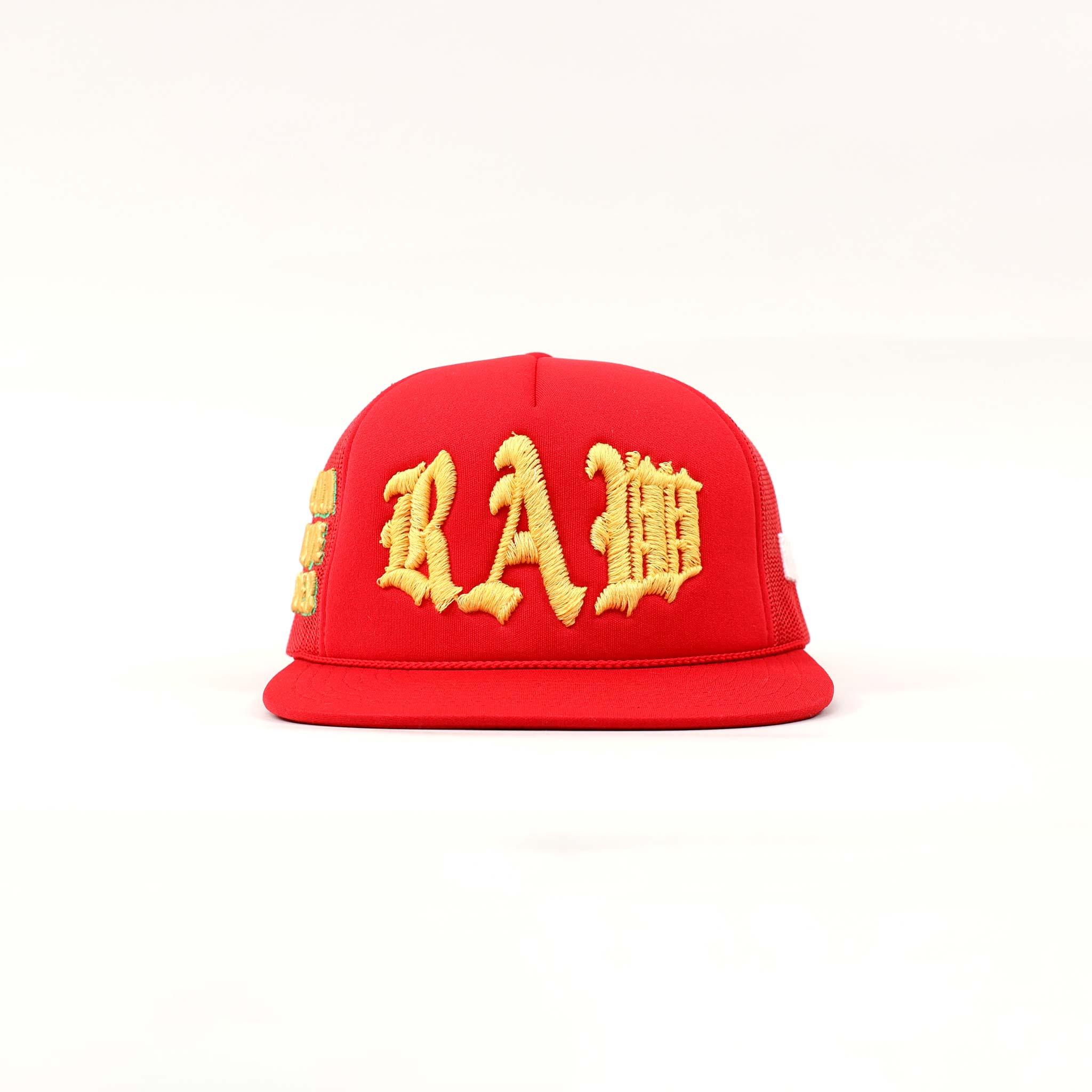 Red cap with yellow embroidered letters.
