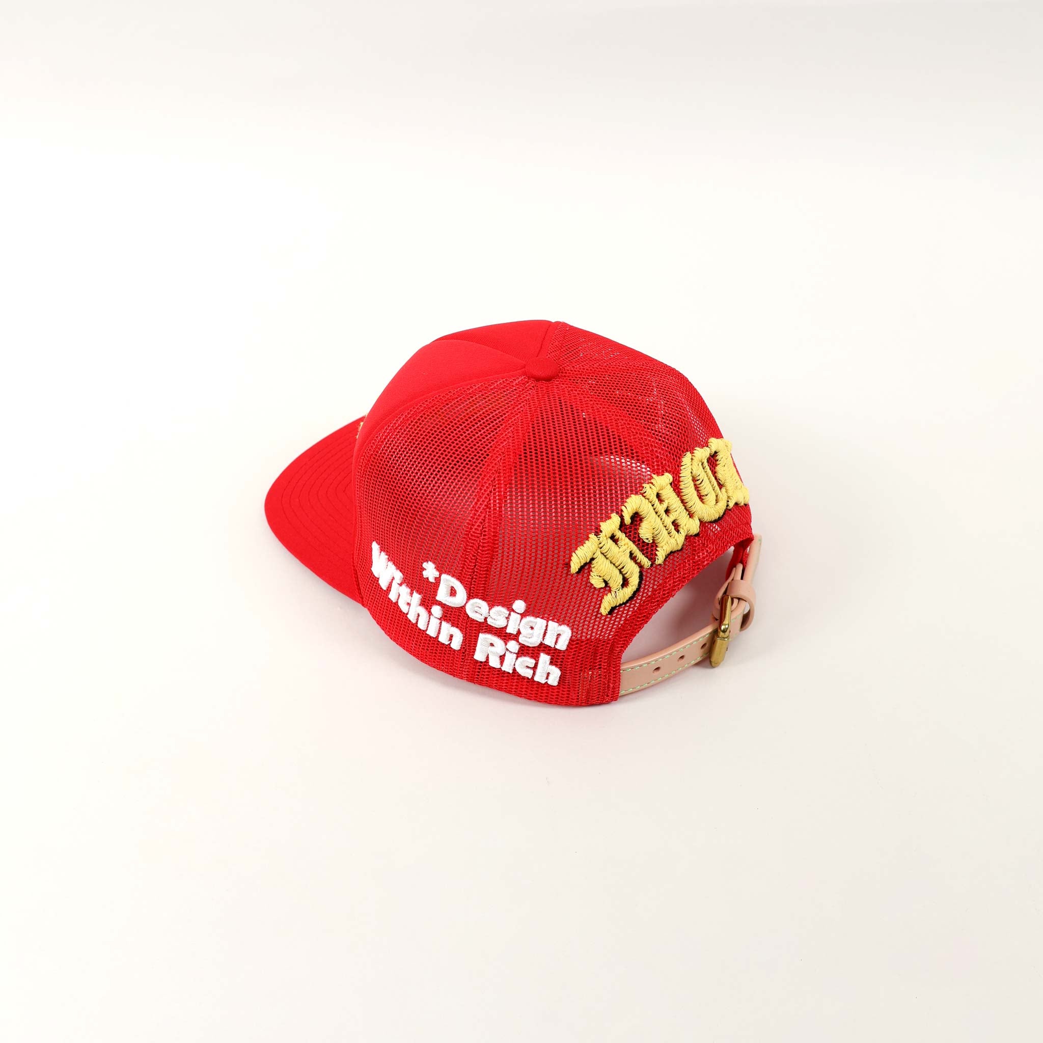 Red cap with "Design Within Rich" text.