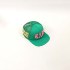 Green cap with pink and yellow embroidery.