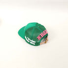 Green mesh cap with pink and white text.