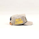 Beige cap with "Art is a Crime" text.