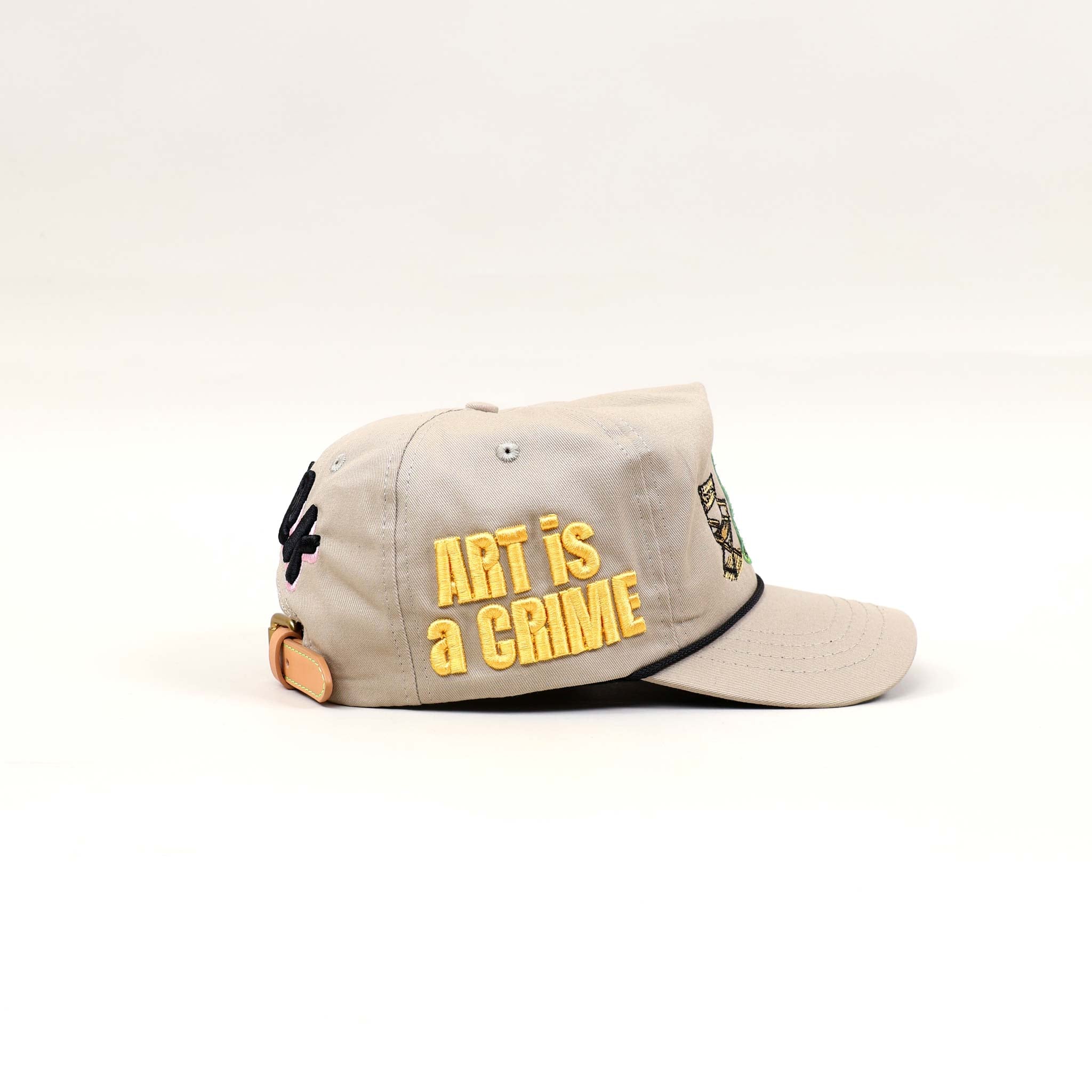 Beige cap with "Art is a Crime" text.