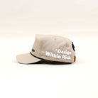 Beige cap with embroidered text.