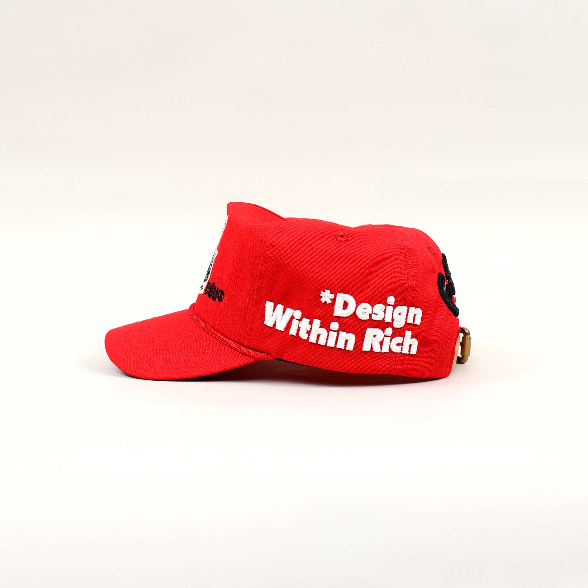 Red cap with "Design Within Rich" text.