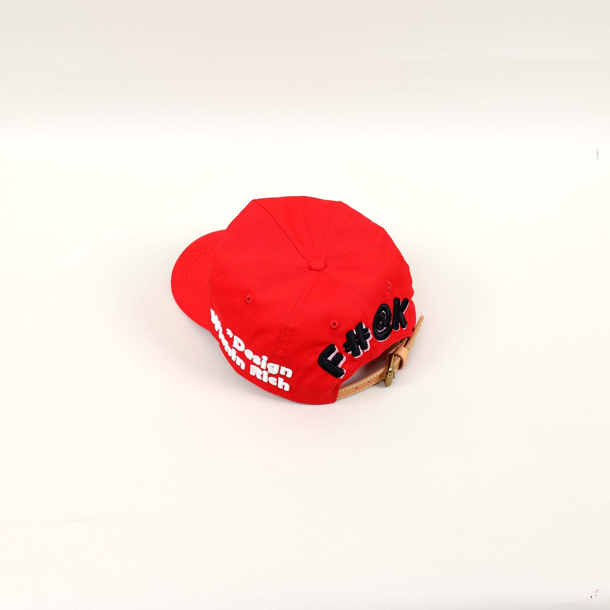 Red cap with embroidered text on the back.