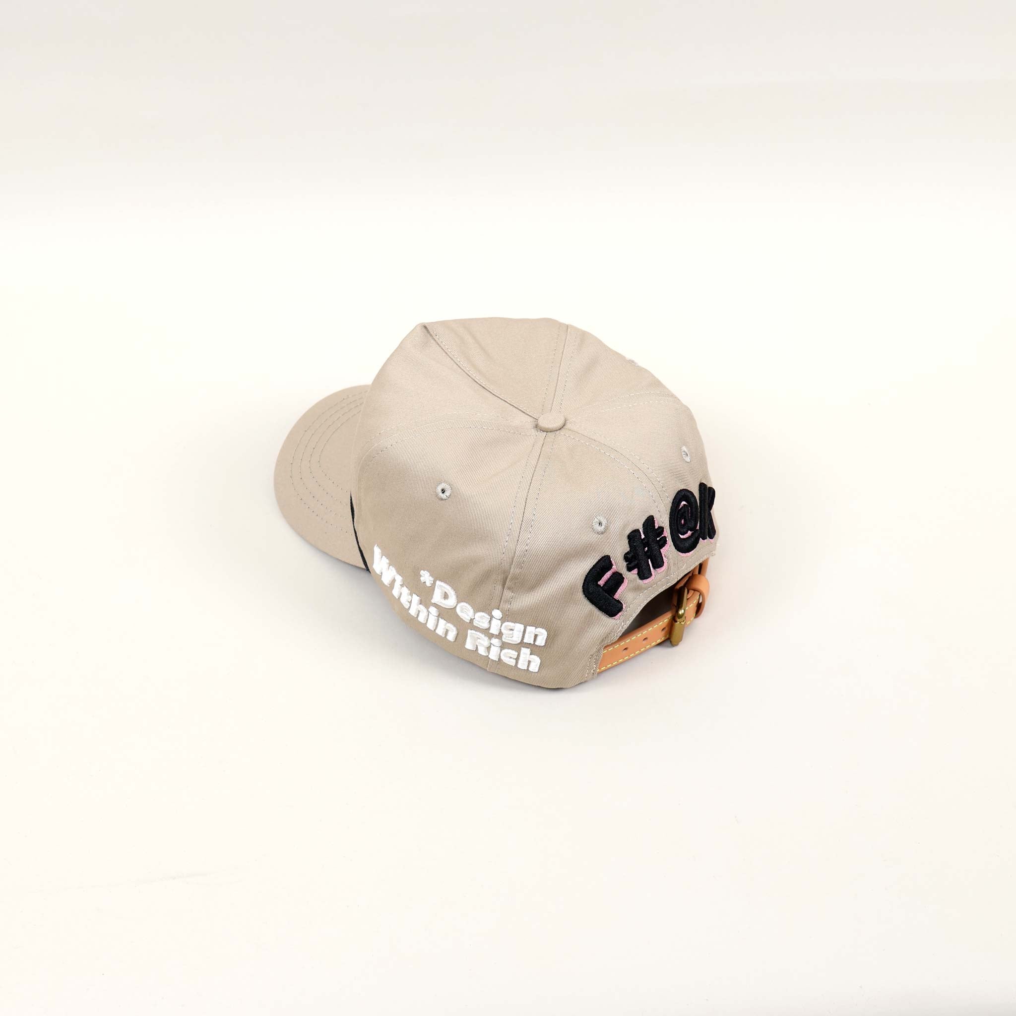 Beige cap with text design on back.