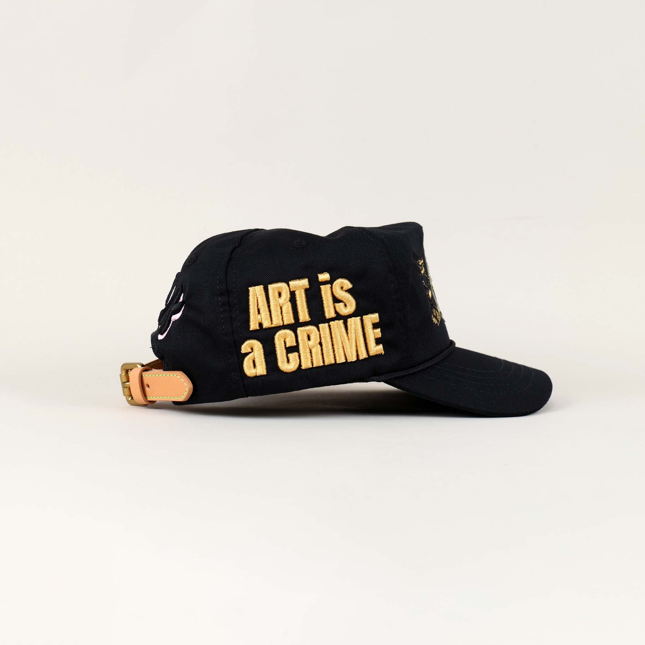 Black cap with "Art is a Crime" text.