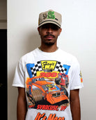 Man wearing graphic racing shirt and cap.