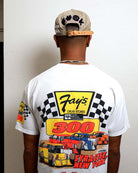 Man wearing racing-themed shirt and cap, back view.