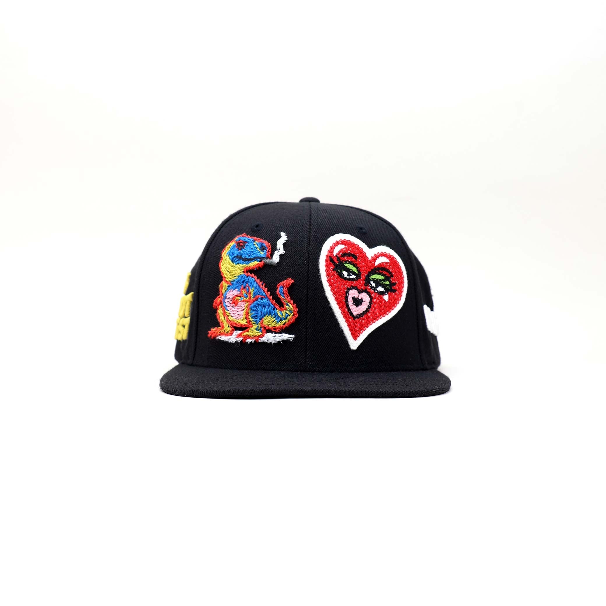 Black cap with flat bill, colorful designs, and text. 